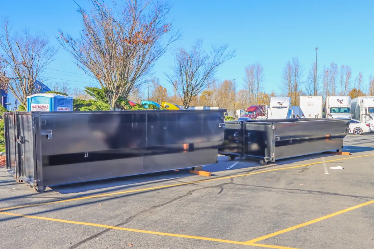 Professional dumpster rental service with roll-off container on residential driveway in Williams